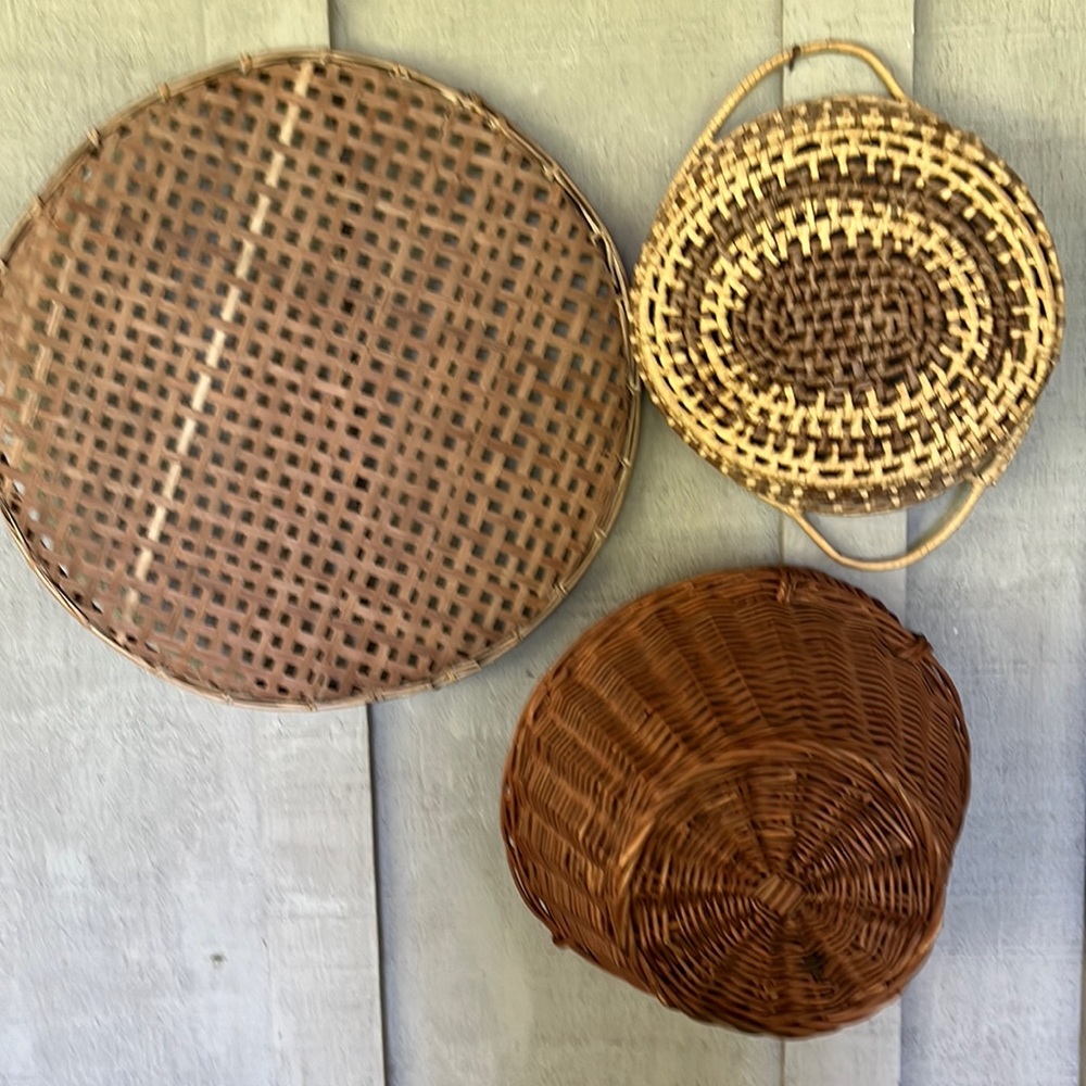 3 Decorative woven baskets of various colors and designs.